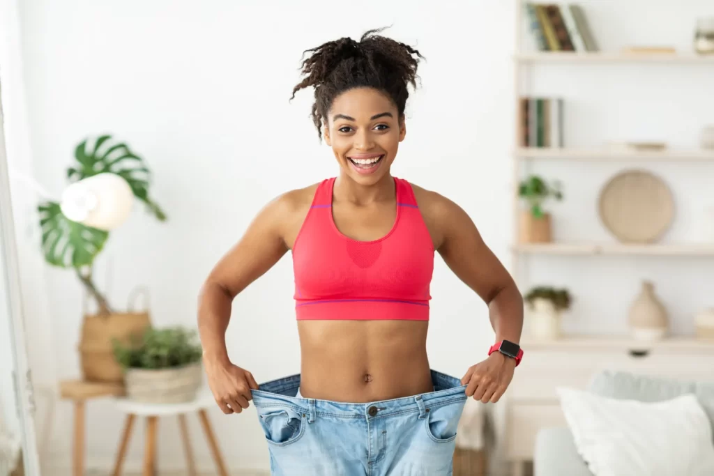 african woman after slimming showing old oversize utc