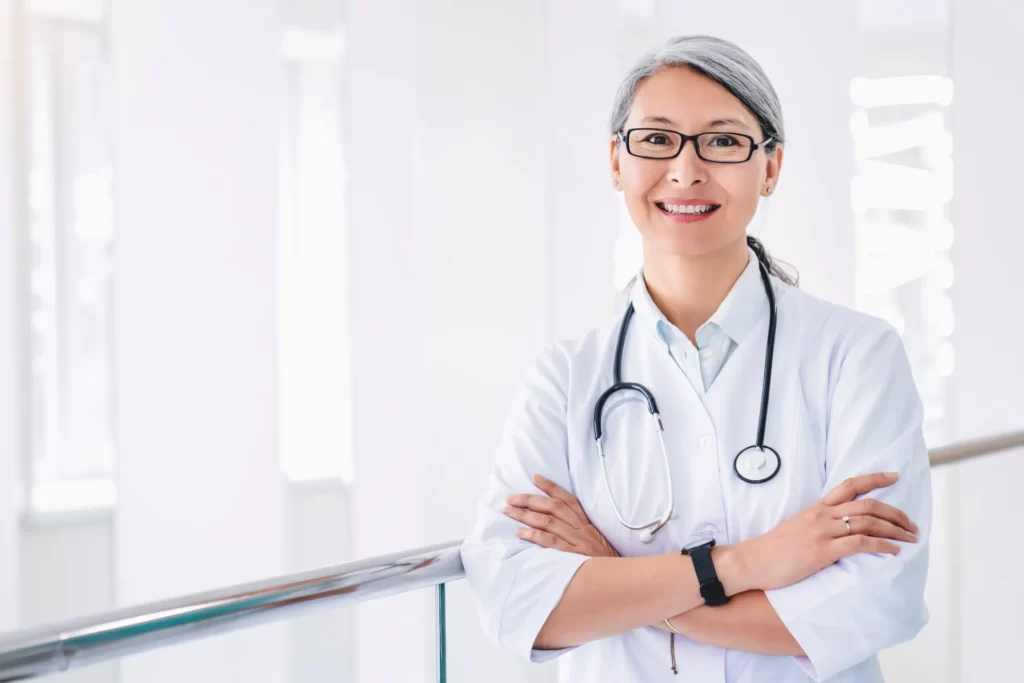 portrait of middle aged asian female doctor standi utc ()