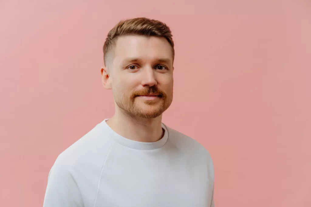 serious man with stubble looks directly at camera utc